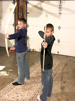 two boys with homemade bows