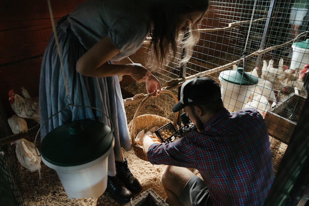 Man in Blue and White Plaid Button Up T-shirt Holding Brown Dog