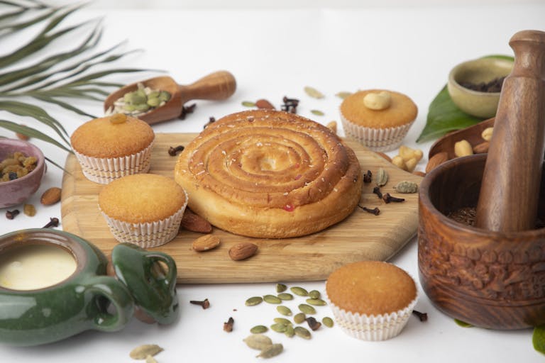 Bread and Cupcakes on Wooden Board
